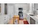 Well-lit kitchen featuring stainless appliances, tile backsplash, and wooden movable island at 109 Grinnell Pl, Celebration, FL 34747