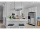 Bright kitchen with stainless appliances, white cabinets, and a stylish quartz breakfast bar at 109 Grinnell Pl, Celebration, FL 34747