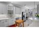Modern kitchen with stainless appliances, white cabinets and countertops, and natural light at 109 Grinnell Pl, Celebration, FL 34747