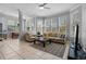 Bright and airy living room with neutral tones, tile flooring, and large windows offering abundant natural light at 109 Grinnell Pl, Celebration, FL 34747