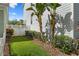 Green side yard featuring a well-manicured lawn, lush plants, and a privacy fence at 109 Grinnell Pl, Celebration, FL 34747
