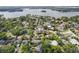 Scenic aerial view of a neighborhood with tree-lined streets and a glimpse of a serene lake at 113 Tangelo Ct, Maitland, FL 32751