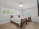 Bright bedroom with wood-look tile floor, two twin beds, and plantation shutters on the windows at 113 Tangelo Ct, Maitland, FL 32751