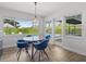 Sunny dining area featuring a modern table set, large windows, and access to the outdoors at 113 Tangelo Ct, Maitland, FL 32751
