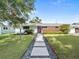 Well-manicured front yard showcasing a charming home with lush green lawn and inviting walkway at 113 Tangelo Ct, Maitland, FL 32751