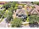 Aerial view of a home displays its location, roof and mature tree canopy at 14522 Old Thicket Trace, Winter Garden, FL 34787
