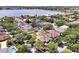An aerial view of lakeside homes showcases the neighborhood's beauty and proximity to the water at 14522 Old Thicket Trace, Winter Garden, FL 34787