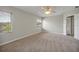 Neutral bedroom featuring carpet, ceiling fan, natural light, and a serene atmosphere at 14522 Old Thicket Trace, Winter Garden, FL 34787