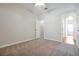Neutral bedroom with carpet floors and view of the hallway at 14522 Old Thicket Trace, Winter Garden, FL 34787