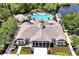 Aerial view of clubhouse with sparkling pool, inviting lounge area, and meticulously landscaped grounds at 14522 Old Thicket Trace, Winter Garden, FL 34787