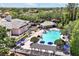 Stunning aerial of a community pool, shaded seating areas, and lush landscaping for ultimate relaxation at 14522 Old Thicket Trace, Winter Garden, FL 34787