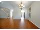 Dining area featuring hardwood floors, chandelier lighting, and an open view to the staircase and kitchen at 14522 Old Thicket Trace, Winter Garden, FL 34787