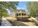 Side view of a charming two-story home with well-maintained landscaping and a spacious front yard at 14522 Old Thicket Trace, Winter Garden, FL 34787