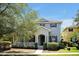 Charming two-story home featuring blue shutters, a covered porch, and well-maintained landscaping at 14522 Old Thicket Trace, Winter Garden, FL 34787