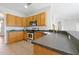 Well-lit kitchen with stainless steel appliances, tile floors, and plenty of counter space at 14522 Old Thicket Trace, Winter Garden, FL 34787