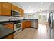 Bright kitchen with stainless steel appliances, tile floors and eat in dining area at 14522 Old Thicket Trace, Winter Garden, FL 34787
