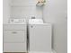Clean, functional laundry room with appliances and storage, ready for household chores at 14522 Old Thicket Trace, Winter Garden, FL 34787
