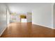 Open-concept living room with wood floors leading to the kitchen and dining area at 14522 Old Thicket Trace, Winter Garden, FL 34787
