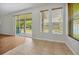 Open-concept living room with tile and wood floors, sliding glass doors to the backyard at 14522 Old Thicket Trace, Winter Garden, FL 34787