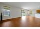 Open concept living room with wood floors, sliding glass doors to the backyard, and natural light at 14522 Old Thicket Trace, Winter Garden, FL 34787