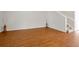 Open living room with hardwood floors, neutral walls, and a staircase leading to the upper level at 14522 Old Thicket Trace, Winter Garden, FL 34787