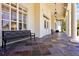 Inviting covered porch with slate tile and comfortable bench seating at 14522 Old Thicket Trace, Winter Garden, FL 34787