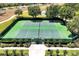 Aerial view of well-maintained tennis courts, surrounded by lush greenery and mature trees at 14522 Old Thicket Trace, Winter Garden, FL 34787