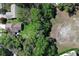 An aerial view shows the home's location bordering a wooded area at 1512 Southwind Ct, Casselberry, FL 32707