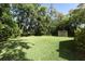 Expansive back yard featuring mature trees and a storage shed at 1512 Southwind Ct, Casselberry, FL 32707