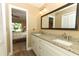 Bathroom features a double vanity, granite countertops and a large mirror at 1512 Southwind Ct, Casselberry, FL 32707