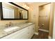 Well-lit bathroom featuring dual sinks, granite counters, and updated fixtures at 1512 Southwind Ct, Casselberry, FL 32707