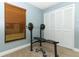 A simple bedroom with window, blinds, closet, weight bench and dumbbells for home fitness activities at 1512 Southwind Ct, Casselberry, FL 32707