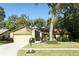 Charming single-story home with a well-maintained lawn, mature trees, and stone accents enhancing its curb appeal at 1512 Southwind Ct, Casselberry, FL 32707