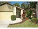 Inviting home entrance with a stone-accented porch, lush landscaping, and a well-manicured lawn at 1512 Southwind Ct, Casselberry, FL 32707
