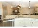 Open concept kitchen with granite countertops, stainless steel dishwasher and modern lighting at 1512 Southwind Ct, Casselberry, FL 32707