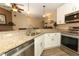 Bright kitchen features stainless steel appliances, granite countertops, and white cabinets at 1512 Southwind Ct, Casselberry, FL 32707