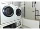 Convenient laundry room with modern washer, dryer and built-in storage solutions and utility sink at 1512 Southwind Ct, Casselberry, FL 32707