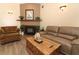 Comfortable living room with a fireplace, warm lighting and views of the kitchen at 1512 Southwind Ct, Casselberry, FL 32707