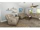 Comfortable living room featuring cozy seating, neutral walls, and a ceiling fan, perfect for relaxing and entertaining at 1512 Southwind Ct, Casselberry, FL 32707