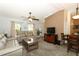 Spacious living room featuring neutral tones, comfortable seating, and a cozy atmosphere with a ceiling fan at 1512 Southwind Ct, Casselberry, FL 32707