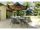 Charming outdoor patio and seating area perfect for enjoying the shade on warm days at 1512 Southwind Ct, Casselberry, FL 32707