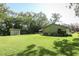 A functional backyard shed with ample space for storage, complementing the well-maintained lawn at 1512 Southwind Ct, Casselberry, FL 32707