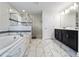 A bathroom featuring a bathtub, glass shower, and dual sinks in front of a decorative mirror at 1571 Palmero Way, Davenport, FL 33896