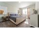 Comfortable bedroom featuring a Queen bed, designer wallpaper, and a sun-filled window at 1571 Palmero Way, Davenport, FL 33896