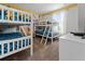 ' bedroom with triple bunk beds, featuring a Minions theme, and abundant natural light at 1571 Palmero Way, Davenport, FL 33896