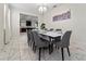 Elegant dining room featuring a modern table with seating for eight, a stylish chandelier, and contemporary artwork at 1571 Palmero Way, Davenport, FL 33896