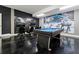 Fun game room with a pool table, gaming chairs, TVs, and striking space-themed wall decor at 1571 Palmero Way, Davenport, FL 33896
