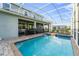 Inviting screened-in pool area with lounge chairs, perfect for relaxing and entertaining outdoors at 1571 Palmero Way, Davenport, FL 33896