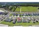 New homes in a suburban community with manicured lawns and sidewalks on a large green space at 1649 Teagan Ln, Winter Haven, FL 33884