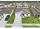 Aerial view of neighborhood homes, showing well-maintained lawns and concrete driveways at 1649 Teagan Ln, Winter Haven, FL 33884